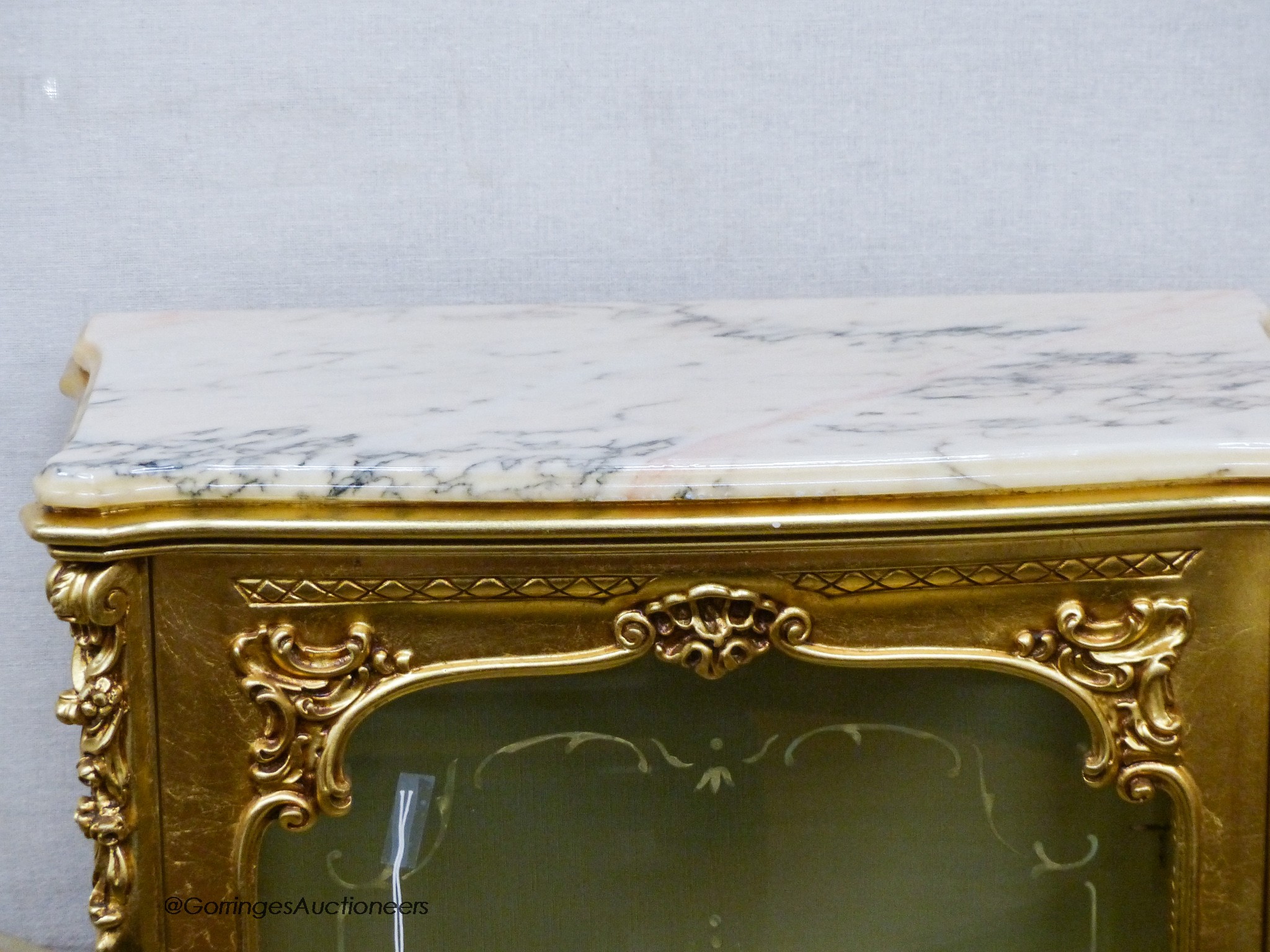 A marble topped gilt vitrine, width 73cm, depth 41cm, height 137cm